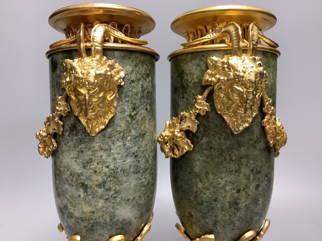 A modern pair of gilt metal and marble urns 32cm